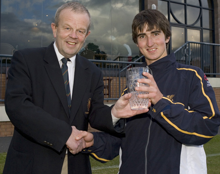 Bangor's Andrew Beard receiving his Down Democrat Man of the Match award for his 4 for 45 against Downpatrick from NCU Sponsorship Officer Richard Johnson