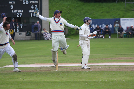 It's all over, Gary Wilson, celebrates catching Waringstown's last man Stuart Kidd (C) John Boomer CricketEurope
